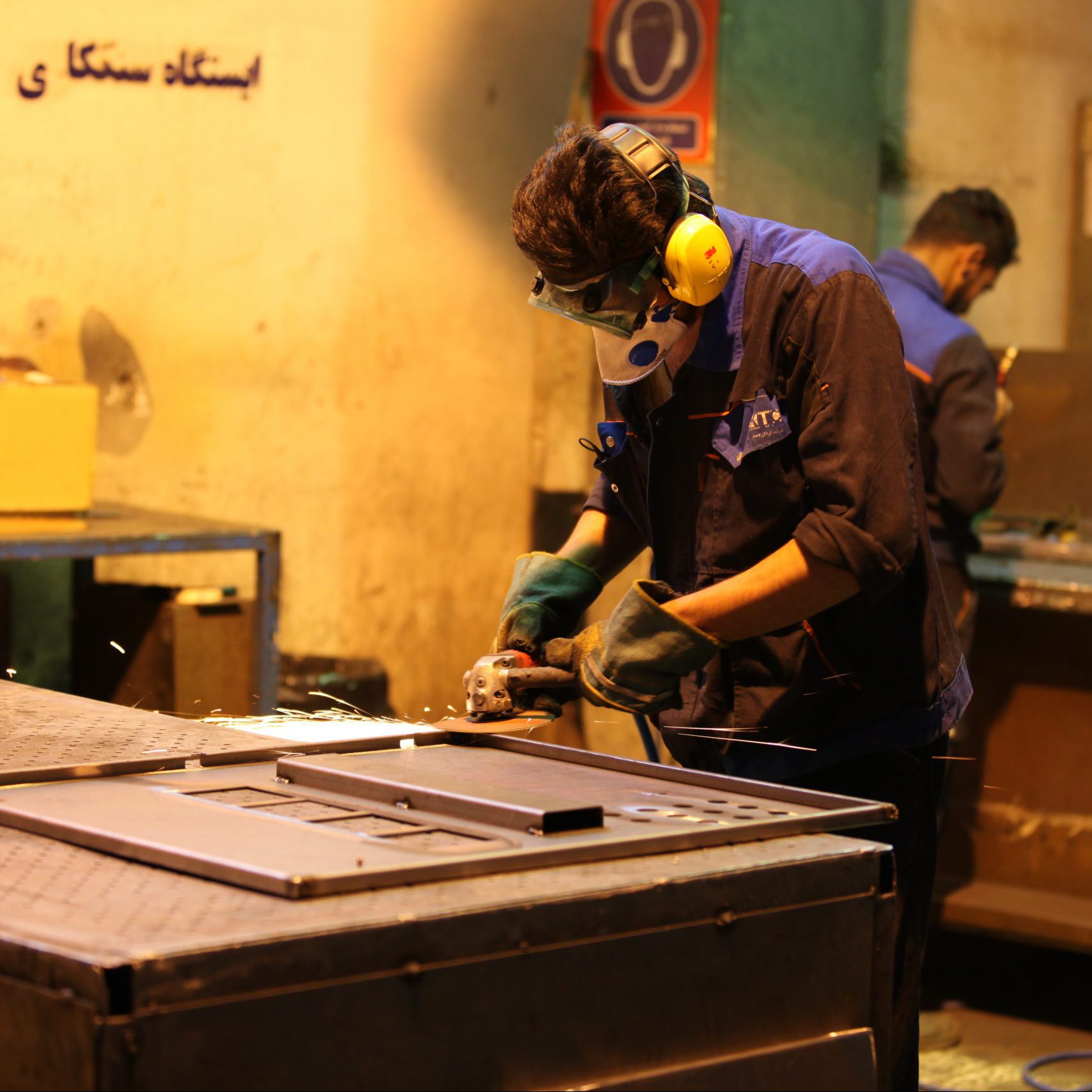man in blue shirt and green pants wearing yellow helmet